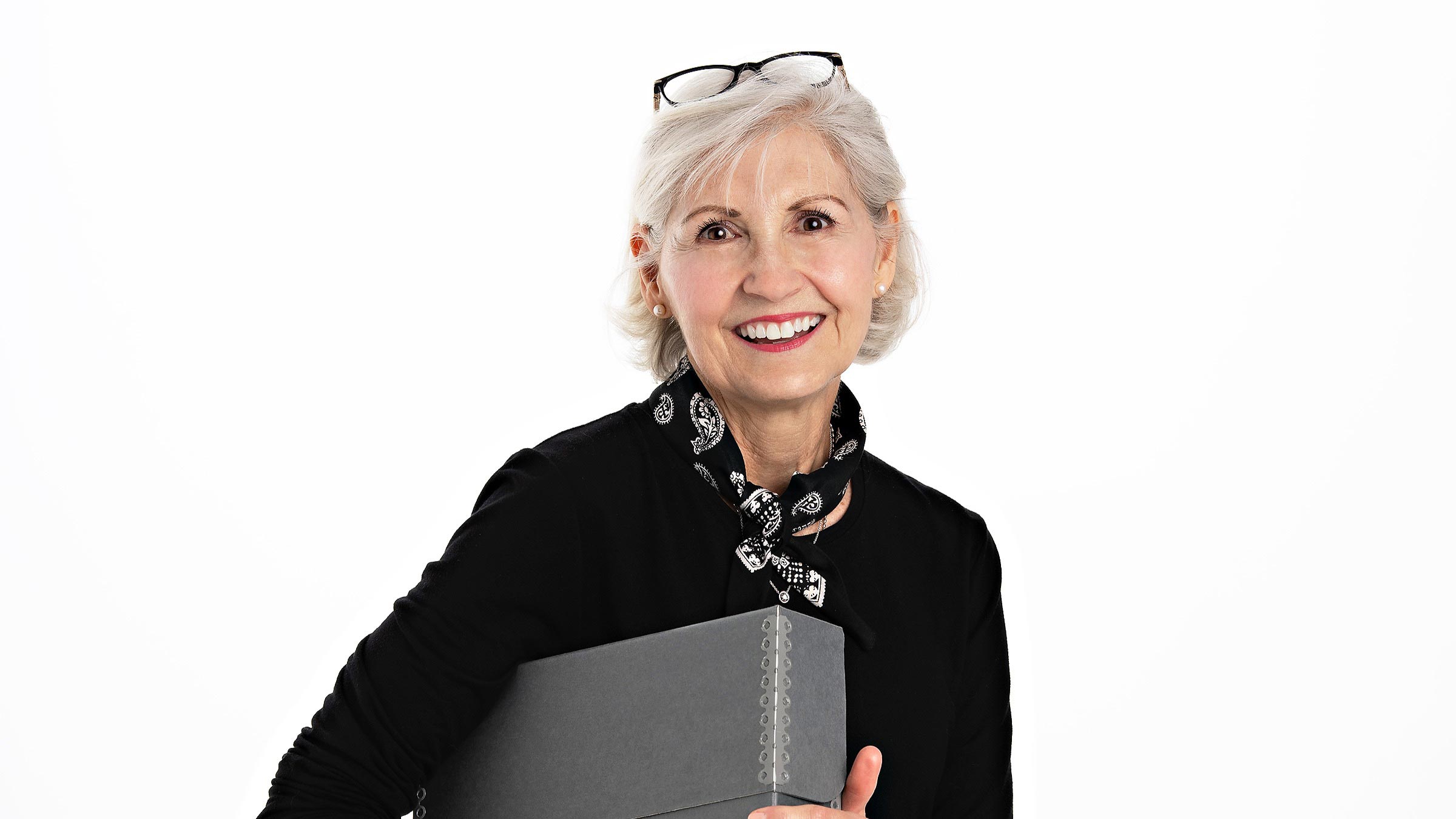 Pamela Mayer with gray archive box.
