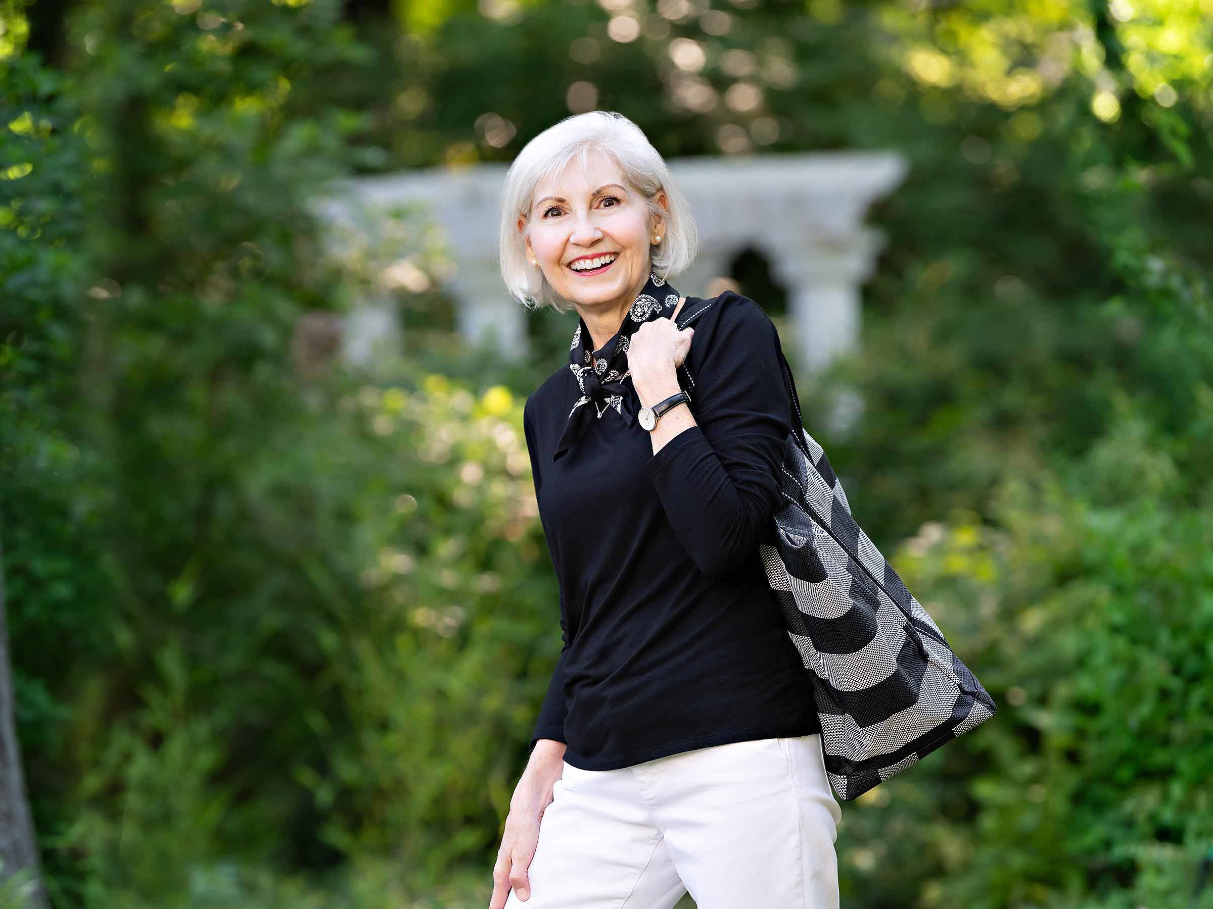 Pamela Mayer walking through a garden.